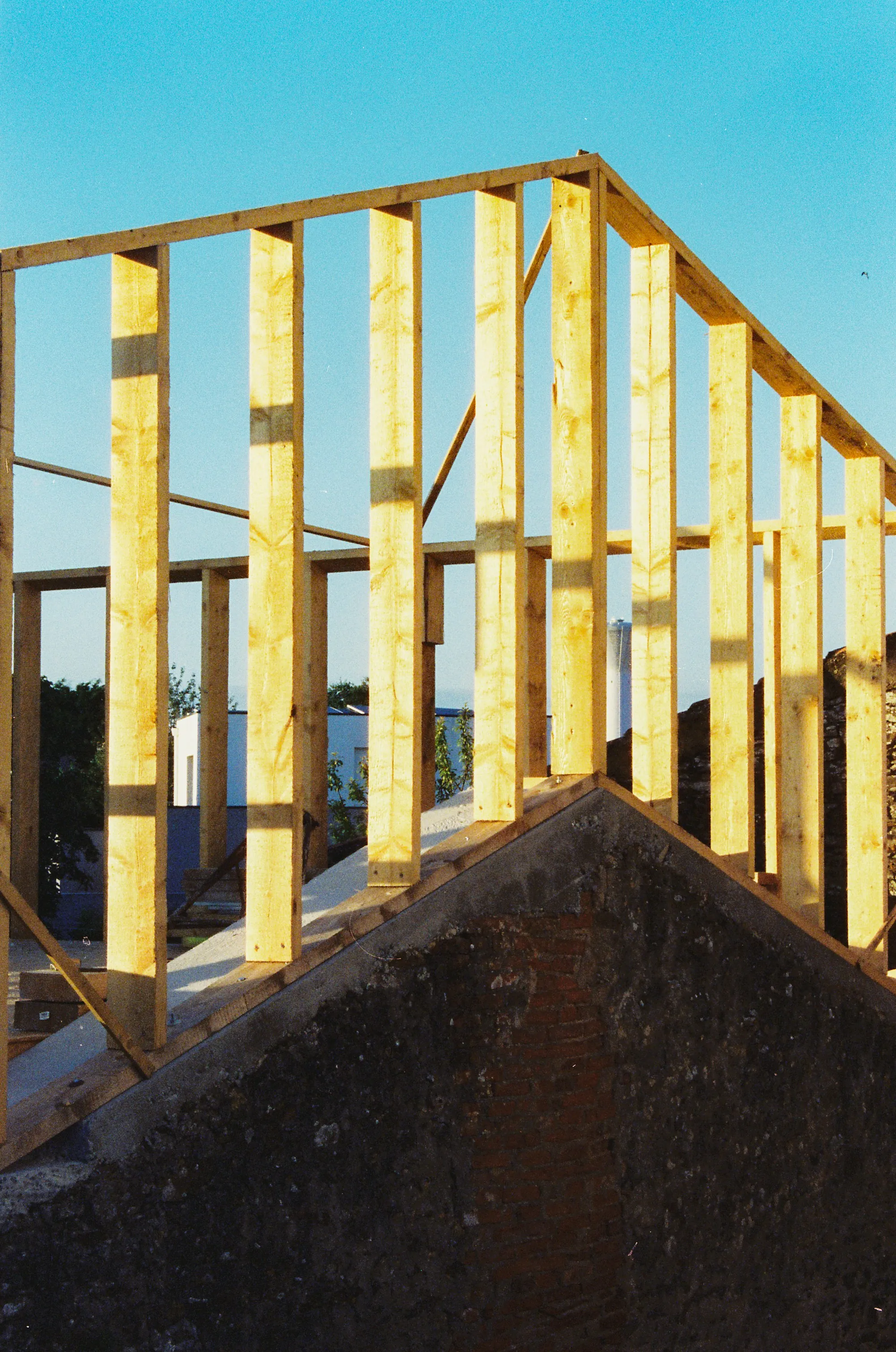 Remodeling project manager reviewing plans on a tablet inside a framed addition