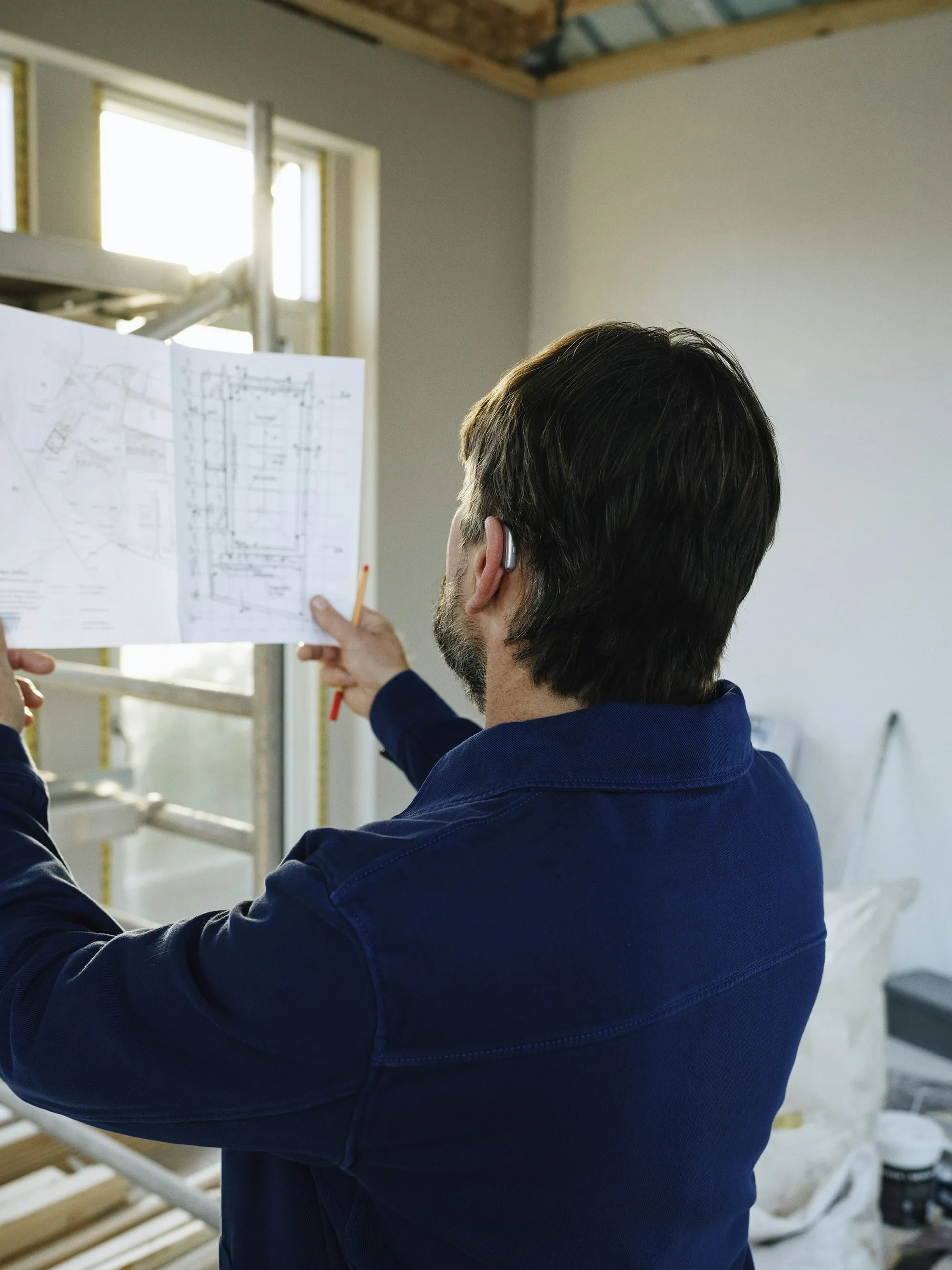 Printed itemized remodeling estimate on a clipboard next to tile samples