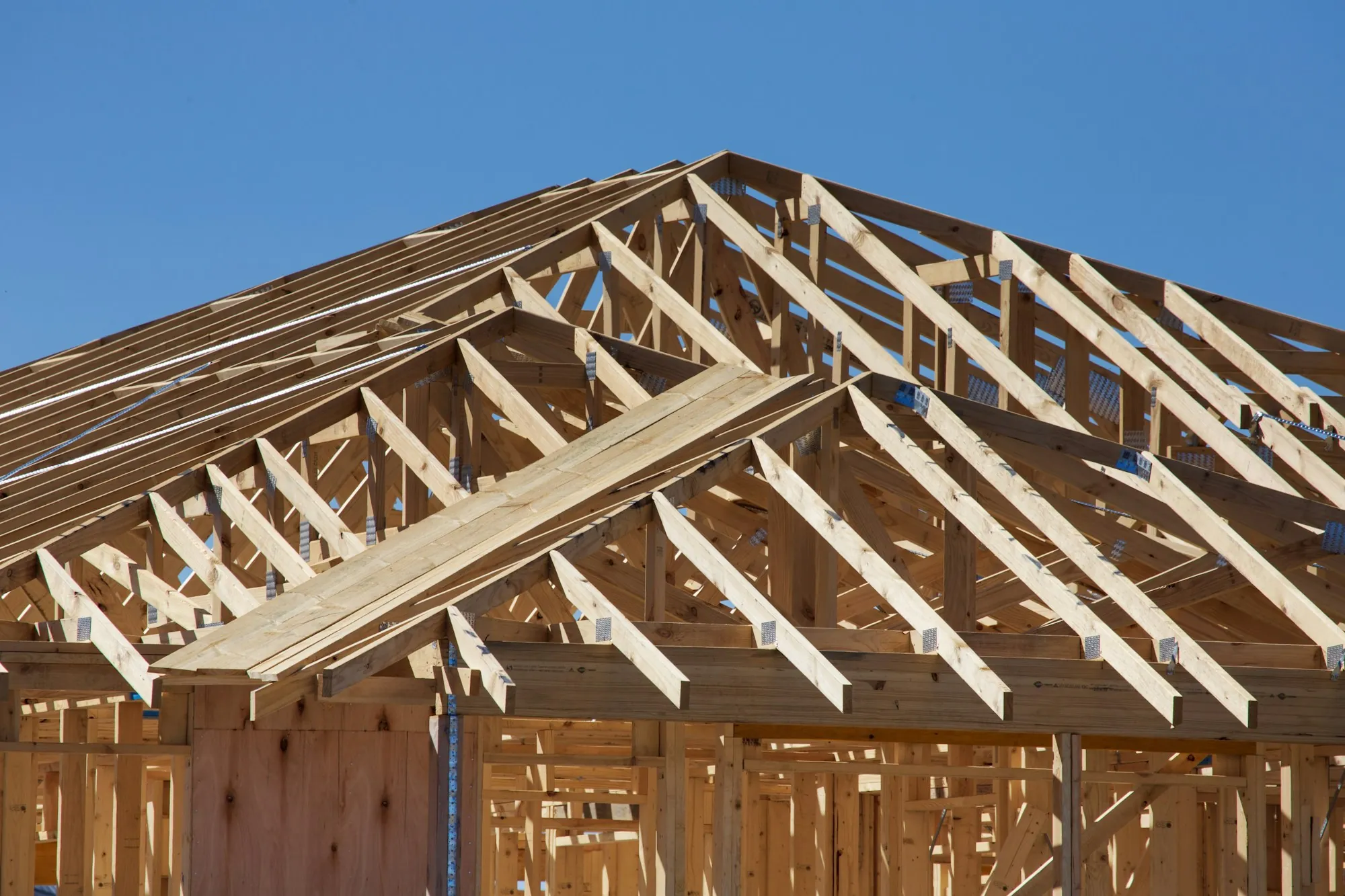 Contractor and homeowner reviewing an itemized scope sheet at a dining table