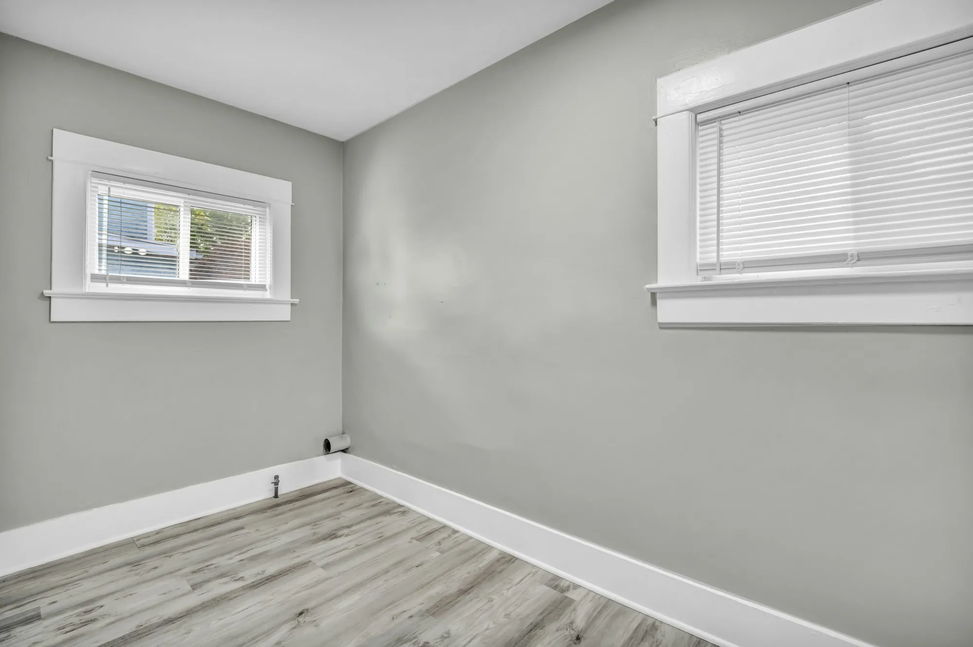 Painter cutting in along a ceiling line with a brush