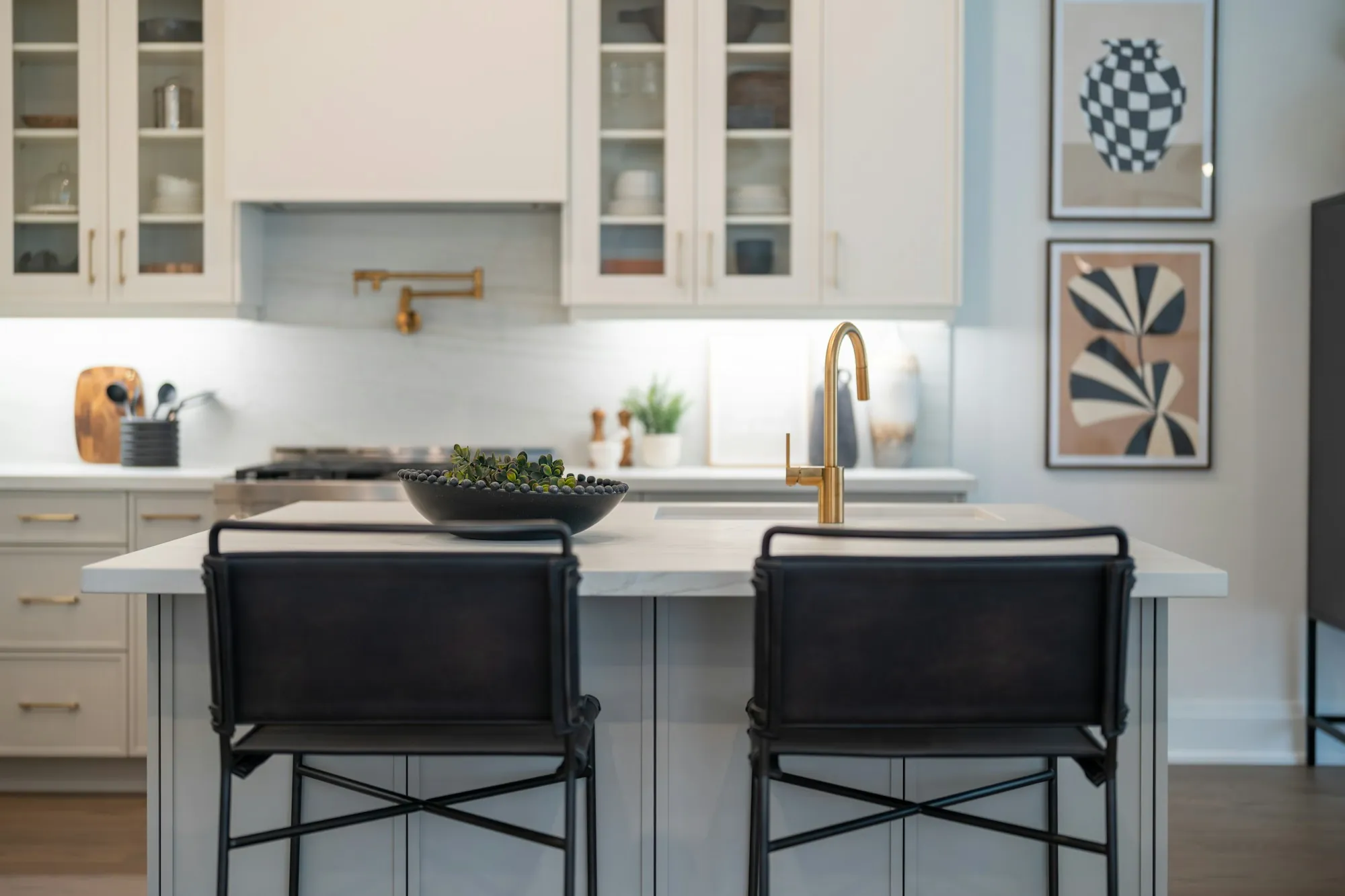 Updated kitchen with white cabinets, a farmhouse sink and under-cabinet lighting
